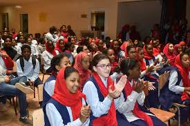Pupils applauding during a school assembly