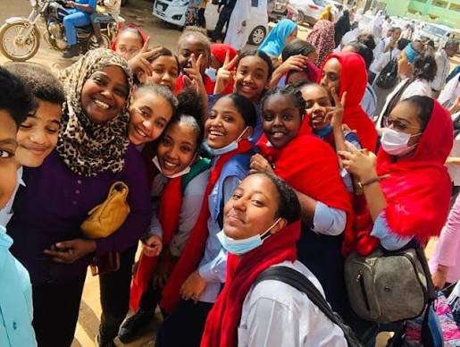 Students of Cambridge International School Sudan gathered outside school with a teacher